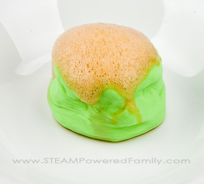 Erupting Slime - A Saline Slime STEM Activity that incorporates the traditional volcano science experiment kids love, with a new slime twist. 