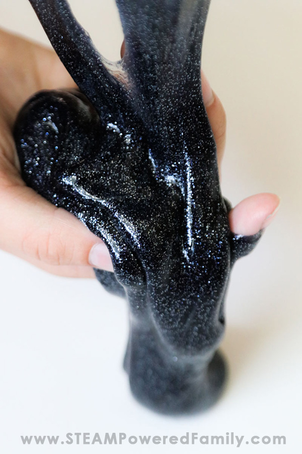 Inky black glittery slime that is perfect for Halloween slime parties and activities