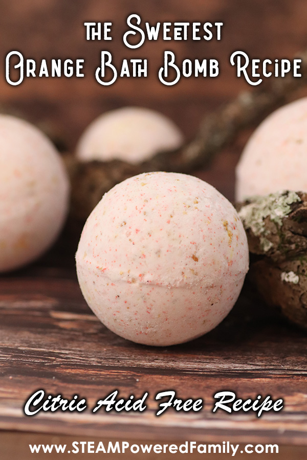 On a dark wood background sits 4 bath bombs amongst some sticks. Overlay Text says The Sweetest Orange Bath Bomb Recipe on the upper part of the image and  Citric Acid Free Recipe on the lower part of the image. 
