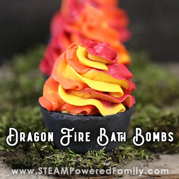 Black cupcake bath bombs with fire red orange and yellow whipped soap toppings sit on a bed of moss. Overlay text says Dragon Fire Bath Bombs