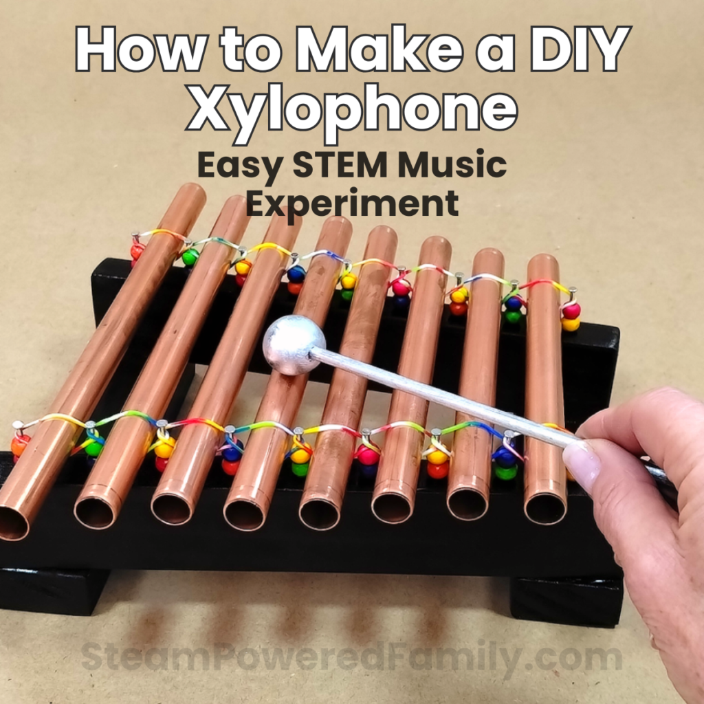 Finished DIY Xylophone made from copper pipes mounted on a painted wooden base, ready to play as a STEM music project for kids.